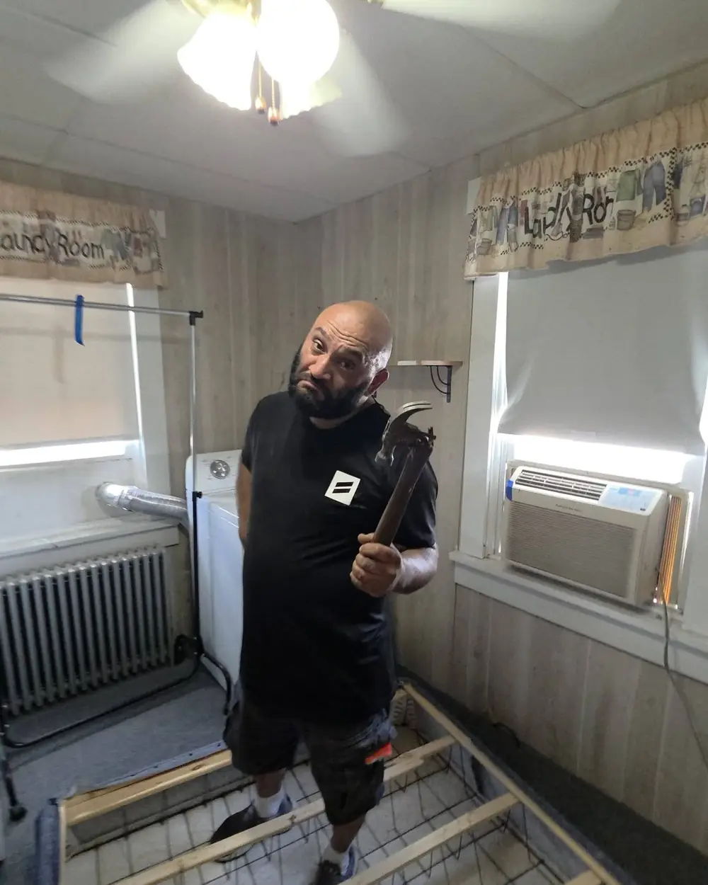 One of the owners carrying a load down a staircase during a cleanout