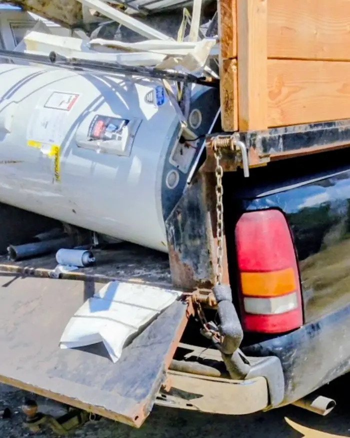 A water heater, railings and metal parts loaded separately on site so they go to scrap rather than to landfill.