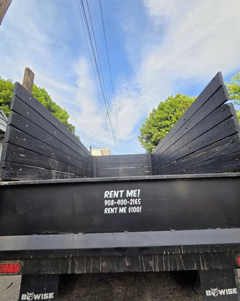 The BeWise dump trailer with RENT ME painted on the tailgate