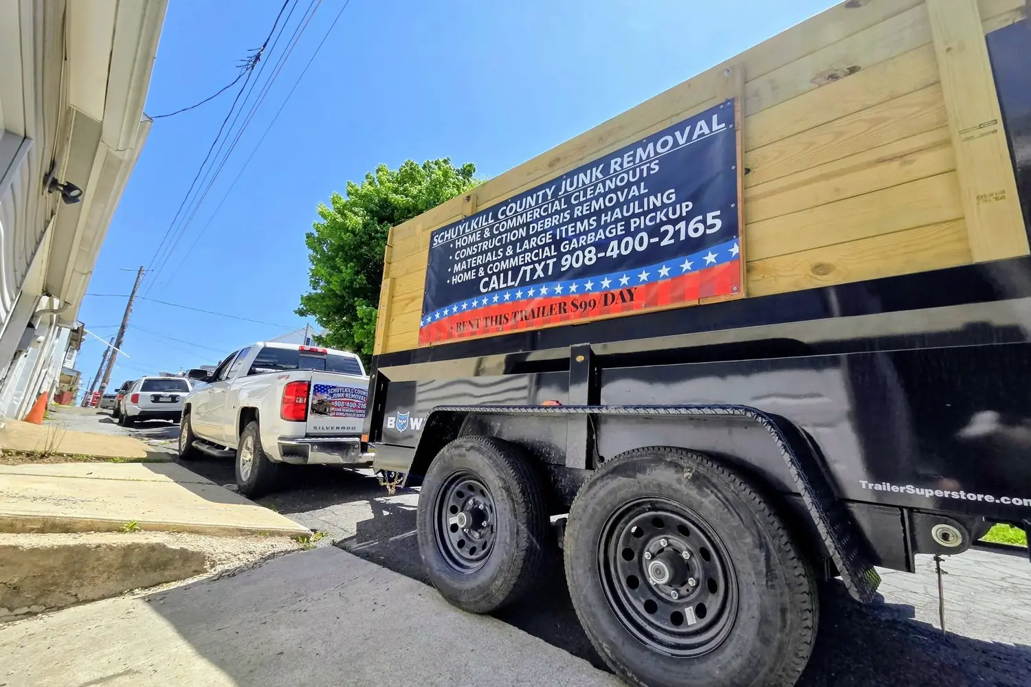 The dump trailer and truck on a street in the service area